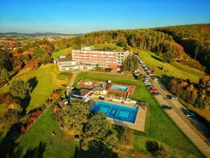 an aerial view of a building with a swimming pool at Hotel Lázně Kostelec in Zlín