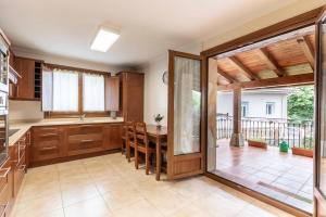 a kitchen with a table and a dining room at Caserío entre Bilbao y Urdaibai in Morga