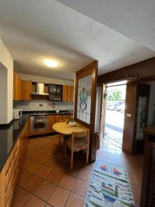 a kitchen with a wooden table and a table at DOLOMITI HOUSE STUBE in Fiera di Primiero