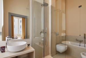 a bathroom with a sink and a toilet and a shower at Hotel Dei Dragomanni in Venice