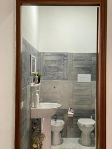 a bathroom with a sink and a toilet at La Finestra Sui Cento Portali in Pignola