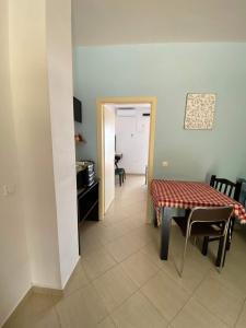 a dining room with a table and chairs and a kitchen at Lirim Shenmiter Lukove in Lukovë +24 photos