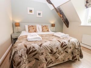 a bedroom with a bed with two towels on it at Two The Chapel - Staveley in Staveley