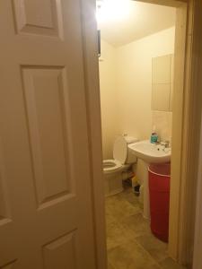 a bathroom with a toilet and a sink at 2 bedroom apartment in Greater Manchester in Ashton under Lyne