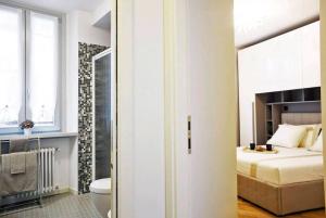 a bedroom with a bed and a bathroom with a toilet at VENTUNO - Modern Apartment - Country & Lake in Lovere