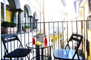 two chairs and a table on a balcony at VENTUNO - Modern Apartment - Country & Lake in Lovere