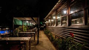 a row of tables outside of a restaurant at night at Fener Motel in Şile