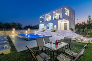 a luxury villa with a swimming pool at night at Boheme Villas close access to Laganas Resort in Zakynthos Town