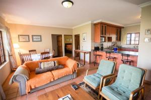 a living room with a couch and two chairs at Paul's Place in Dullstroom