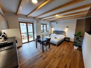a bedroom with a bed and a table in a room at Apartments Hlapi with SPA in Kobarid