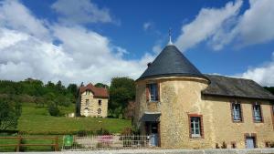 Saint-Agnan-sur-Sarthe的住宿－La Tourelle，一座古老的砖砌建筑,山上有塔