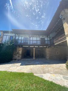 a house with a balcony on top of it at Posada La Lomba in Hermosa