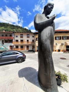 a statue of a woman standing in a parking lot at Apartments Hlapi with SPA in Kobarid