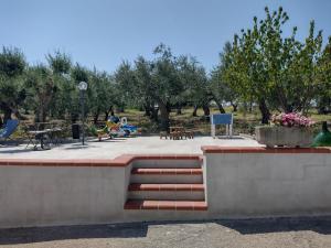 park z ławkami, stołami i drzewami w obiekcie B&B Pozzo Innamorato w mieście Montenero di Bisaccia