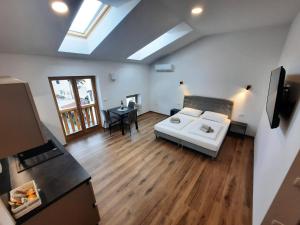 a living room with a white couch and a table at Apartments Hlapi with SPA in Kobarid