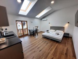 a living room with a white couch and a table at Apartments Hlapi with SPA in Kobarid