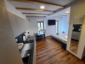a room with a bed and a kitchen and a table at Apartments Hlapi with SPA in Kobarid