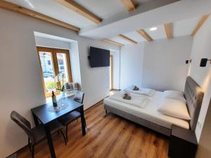 a living room with a bed and a table at Apartments Hlapi with SPA in Kobarid