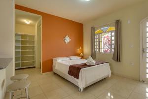 a bedroom with a bed and a window at Pousada Carolina in Florianópolis