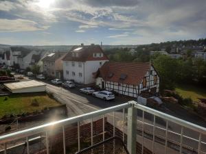 a view of a town with cars parked on a street at Exklusive Wohnoase mit 3 Schlafzimmern MwSt ausweisbar großer Balkon in toller Lage von Melsungen in Melsungen