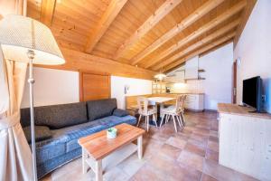 a living room with a couch and a table at Naturresidenz Theistadl Apt 302 in Pracupola