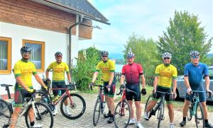 a group of men standing next to their bikes at Apartments Am See in Klopein am Klopeiner See