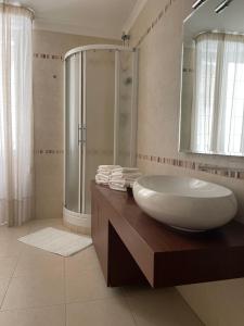 a bathroom with a large sink and a shower at Suite San Cataldo in Taranto