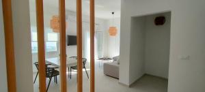 a living room with a table and a dining room at Kelly's Urban Apartment in Elounda