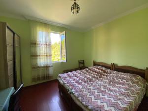 a bedroom with a bed and a window at Venera's Guest House in Batumi