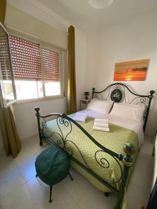 1 dormitorio con 1 cama y 1 silla en Tre passi a mare, en Santa Croce Camerina