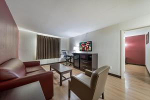 a living room with a couch and a table at Red Roof Inn & Suites Denton in Denton