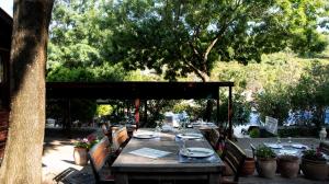 a wooden table with plates and wine glasses on it at Fener Motel in Şile