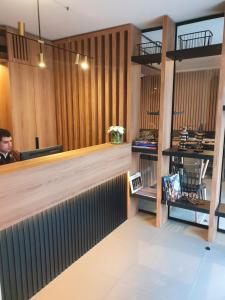 a man sitting at a counter in a restaurant at Lastarria Hotel in Santiago