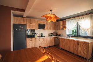 uma cozinha com uma mesa e um frigorífico preto em Blacksea Dream House em Trebizonda