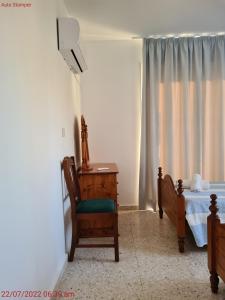 a bedroom with a bed and a chair and a desk at Latchi Area Apartments in Lachi