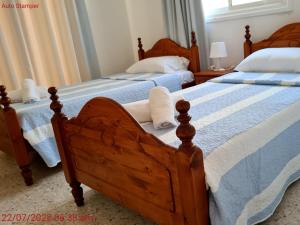 two beds sitting next to each other in a bedroom at Latchi Area Apartments in Lachi