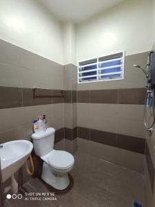 a bathroom with a toilet and a sink at MUSLlM ONLY Pool Wifi 3 aircond room Hospital Sultanah Bahiyah in Alor Setar +8 photos