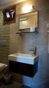 a bathroom with a sink and a mirror at Fener Motel in Şile