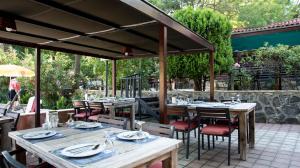 an outdoor dining area with tables and chairs at Fener Motel in Şile