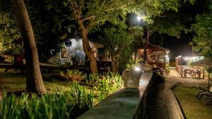 a garden at night with a house in the background at Fener Motel in Şile