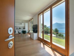 a living room with a large window with a view at Terrazze di Costa - Gardegna 3 in Bellano