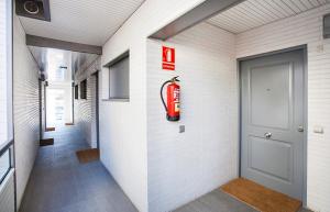 a fire extinguisher sign on the wall of a hallway at Durlet Rambla Mar Apartments in Barcelona