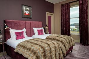a bedroom with two beds and a large window at Malmaison Dundee in Dundee +56 photos