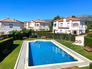 a swimming pool in the yard of a house at Arenda Pino Alto MASIA4 in Hospitalet de l'Infant