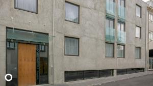 a stone building with a wooden door on a street at Thingholt by Center Hotels in Reykjavík