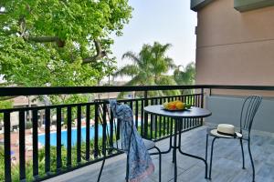 a balcony with a table and chairs and a pool at Amaranda B&B in Catania