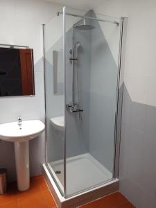 a shower with a glass door next to a sink at Casa Abian in Arrecife