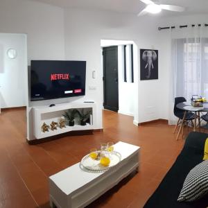 a living room with a tv and a table at Casa Abian in Arrecife