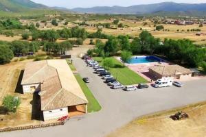 an aerial view of a parking lot with a pool at Kampaoh Cabañeros in Navas de Estena