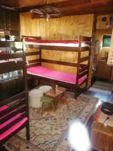 a room with two bunk beds and a table at Mala Kelja in Rudnik